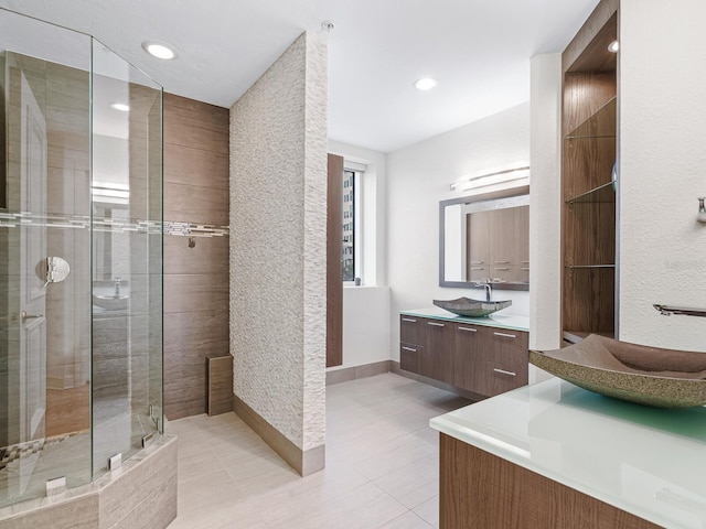 bathroom featuring vanity, tile patterned floors, and a shower with shower door