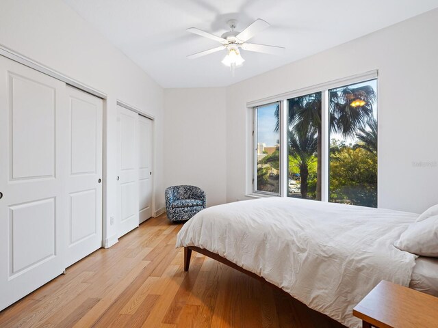 340 S Palm Ave Unit 15, Sarasota, FL 34236 - bedroom featuring two closets, light wood-style floors, and ceiling fan