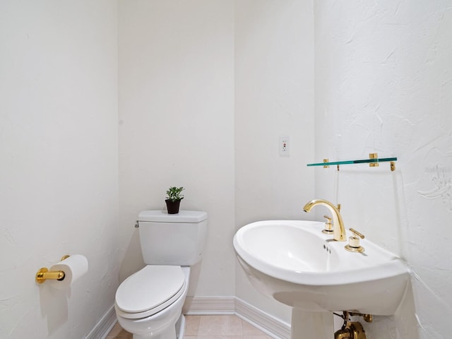 bathroom with sink, tile patterned flooring, and toilet