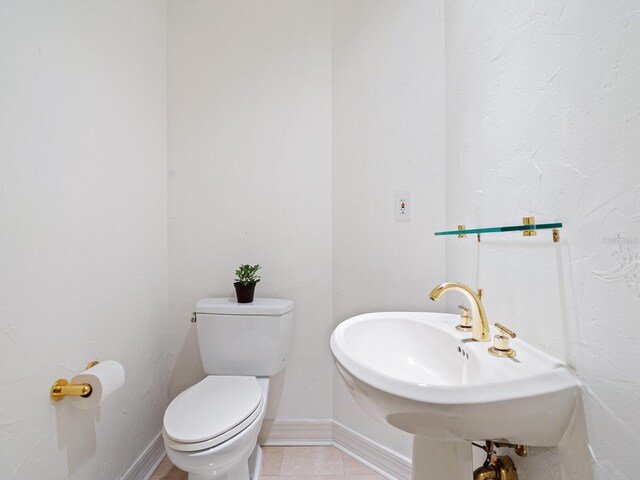 340 S Palm Ave Unit 15, Sarasota, FL 34236 - bathroom with toilet, baseboards, tile patterned flooring, and a sink