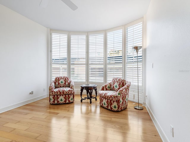 sitting room featuring ceiling fan, a healthy amount of sunlight, and light hardwood / wood-style flooring