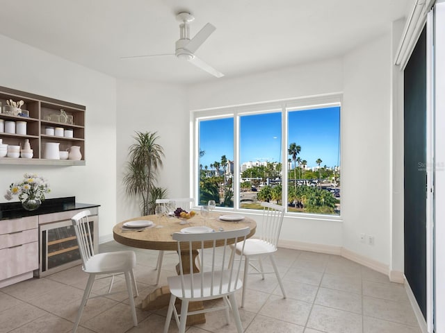 dining area with wine cooler, ceiling fan, and light tile patterned floors