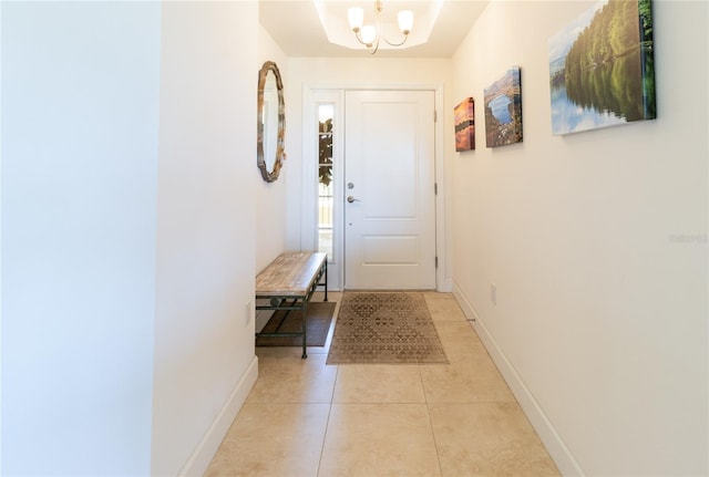 entryway featuring an inviting chandelier and light tile flooring