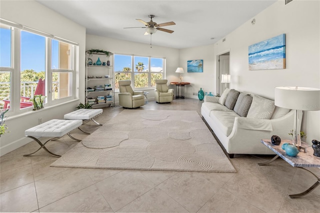 living room featuring light tile floors and ceiling fan