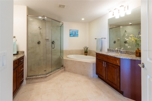 bathroom featuring vanity, tile flooring, a textured ceiling, and shower with separate bathtub