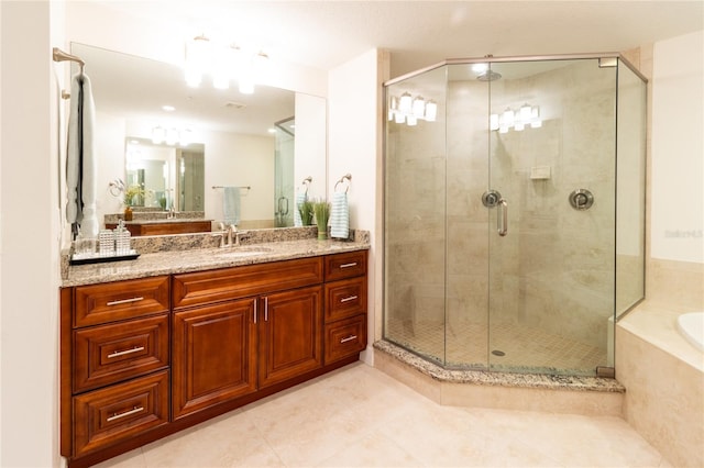 bathroom featuring independent shower and bath, tile flooring, and vanity