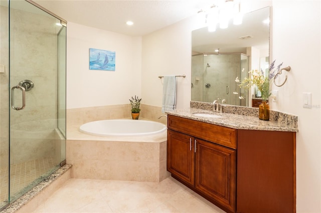 bathroom with tile floors, large vanity, and separate shower and tub