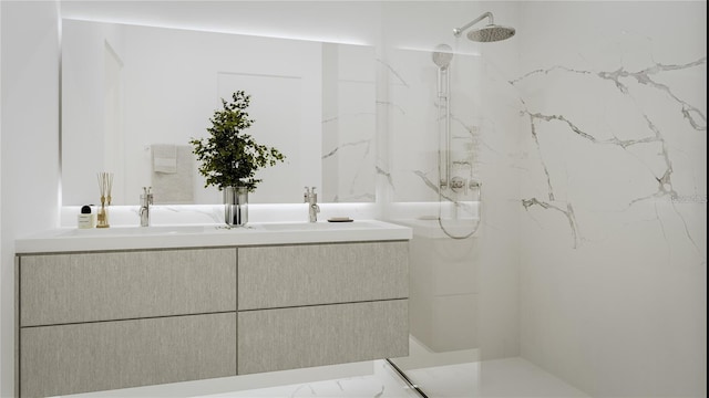 bathroom with a tile shower and sink