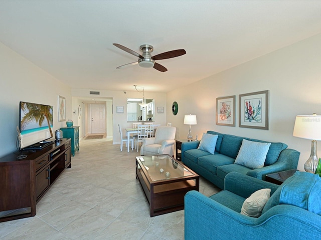 living room with light tile flooring and ceiling fan