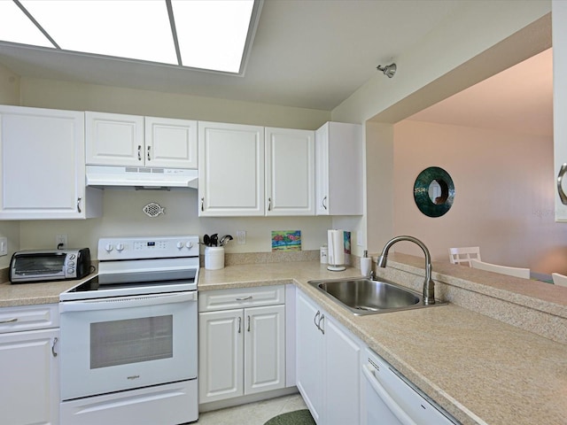 kitchen with white cabinets, light tile flooring, white appliances, and sink