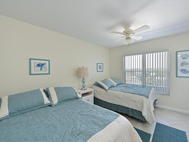 tiled bedroom featuring ceiling fan