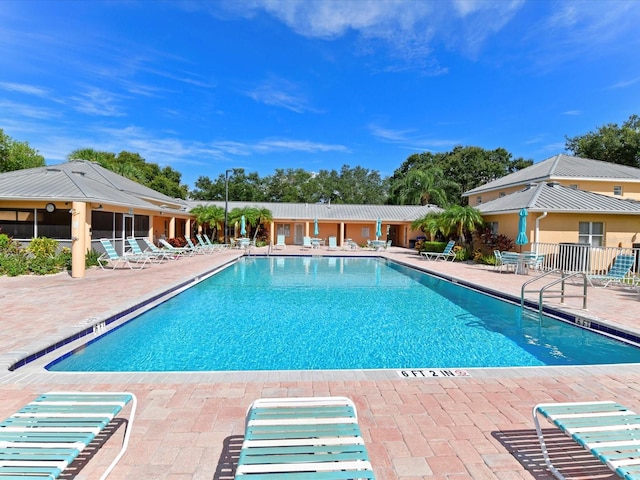 view of swimming pool featuring a patio area