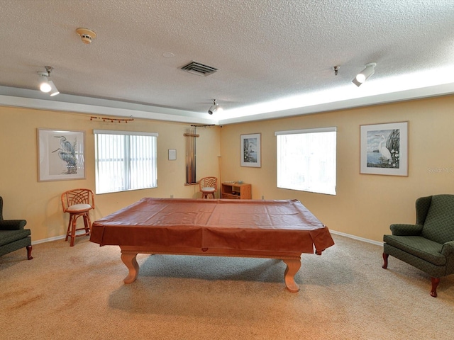 game room with light carpet, billiards, and a textured ceiling