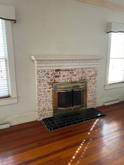 details featuring baseboards, wood finished floors, and crown molding