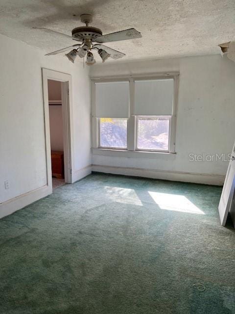 unfurnished bedroom with baseboards, carpet floors, a textured ceiling, and a ceiling fan