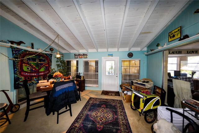 bedroom with multiple windows and vaulted ceiling with beams