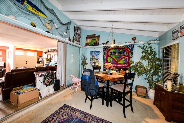 dining room featuring vaulted ceiling with beams