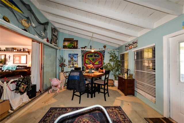 dining room featuring a chandelier and lofted ceiling with beams