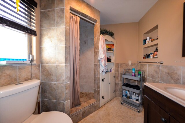 bathroom with built in features, curtained shower, toilet, and tile walls