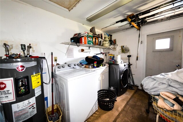 washroom with electric water heater and washing machine and clothes dryer