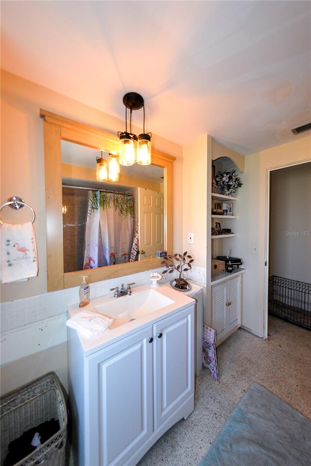 bathroom featuring a chandelier and large vanity