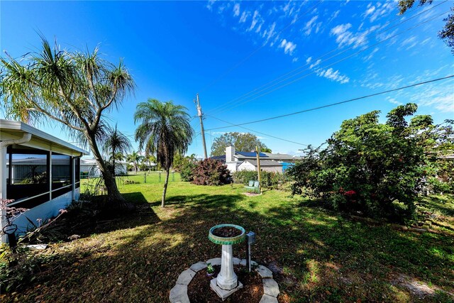 view of yard with a sunroom