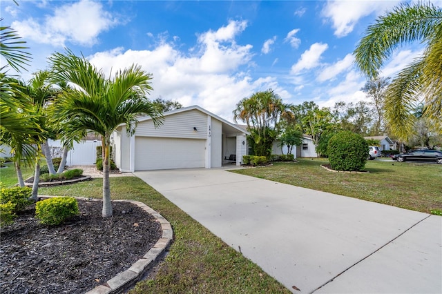 single story home featuring a front lawn and a garage