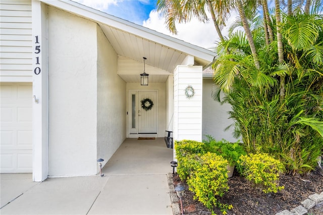 doorway to property with a garage