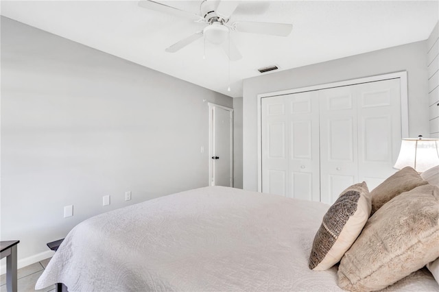 tiled bedroom featuring a closet and ceiling fan