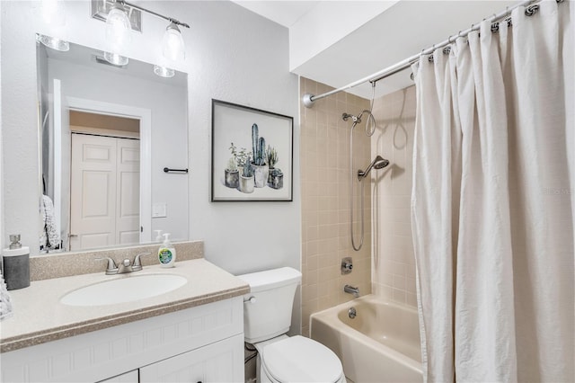 full bathroom featuring shower / bath combination with curtain, toilet, and vanity with extensive cabinet space