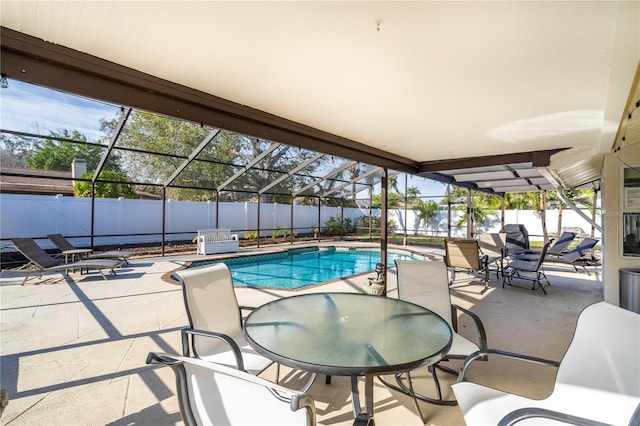 view of pool featuring a patio area and glass enclosure