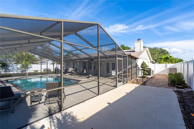 view of swimming pool with a patio and a lanai