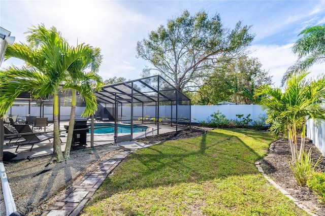 view of yard with a patio, glass enclosure, and a fenced in pool