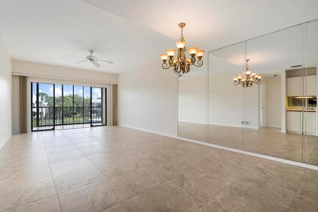 spare room featuring light tile floors and ceiling fan with notable chandelier