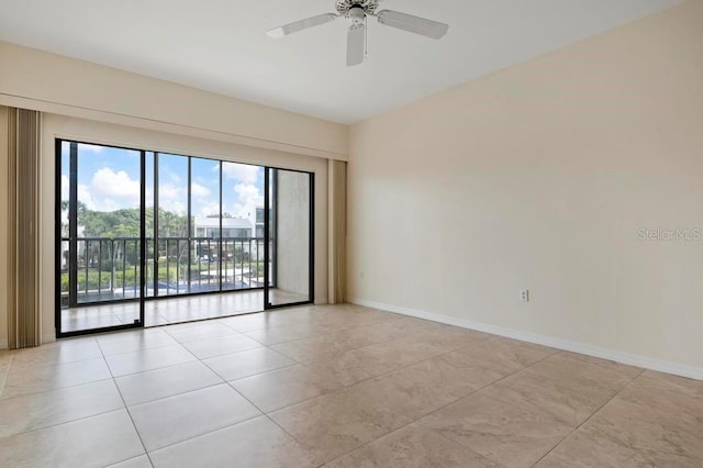 tiled empty room featuring ceiling fan