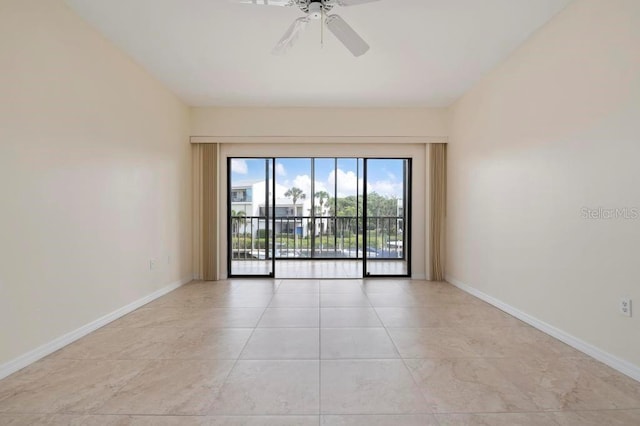 empty room featuring ceiling fan and light tile floors