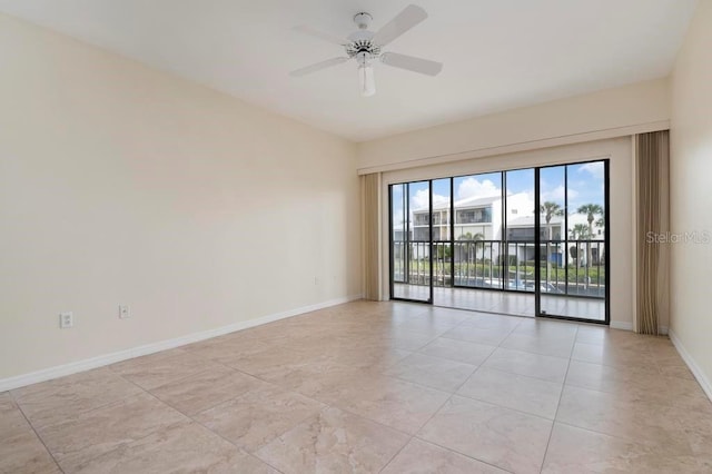 tiled spare room with ceiling fan