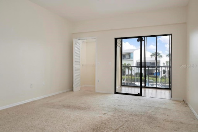 unfurnished room featuring light colored carpet