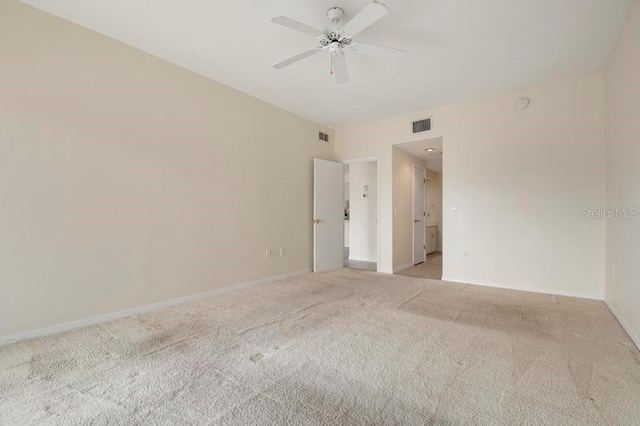 carpeted spare room with ceiling fan