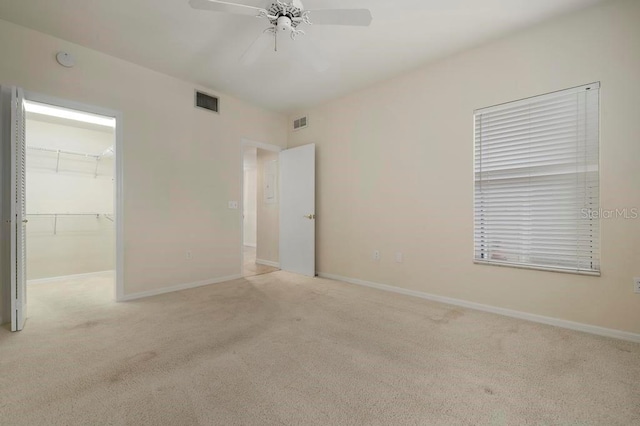 empty room with light carpet and ceiling fan