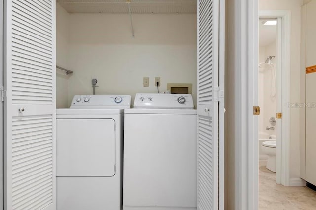 laundry area with hookup for a washing machine, hookup for an electric dryer, light tile flooring, and washing machine and dryer