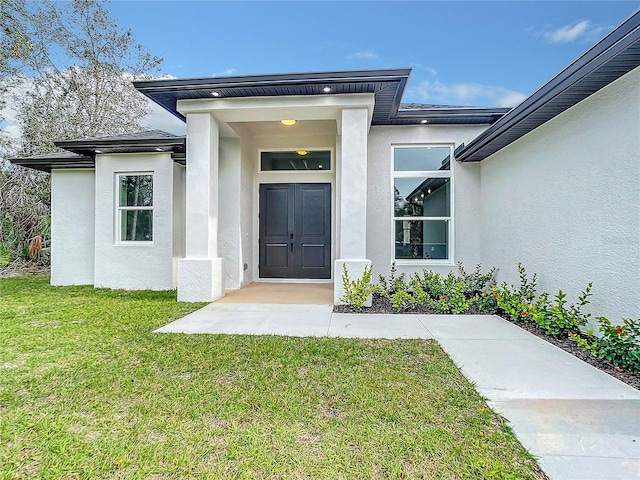 property entrance with a yard