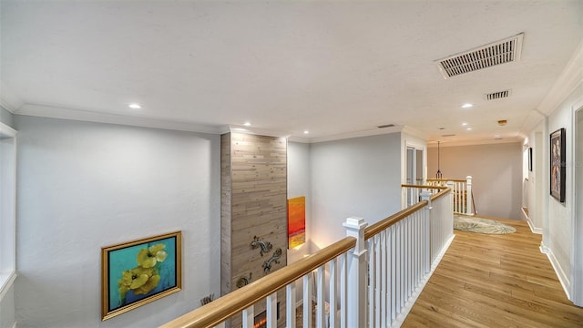 corridor with crown molding and light hardwood / wood-style flooring