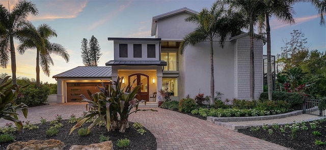 view of front of property with a balcony and a garage