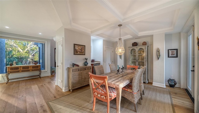 dining space featuring beamed ceiling, coffered ceiling, and light hardwood / wood-style flooring