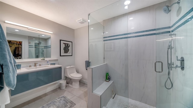 bathroom featuring toilet, vanity, and a shower with shower door