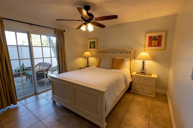 bedroom with a textured ceiling, light tile flooring, ceiling fan, and access to outside