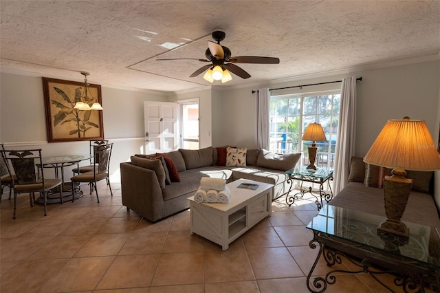 tiled living room with crown molding, a textured ceiling, and ceiling fan with notable chandelier