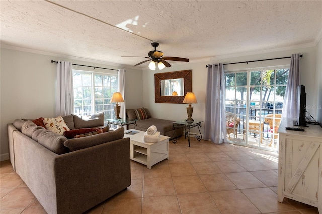 living room with light tile floors, ceiling fan, and a healthy amount of sunlight