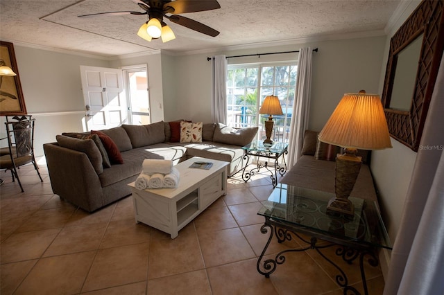 tiled living room featuring ornamental molding, ceiling fan, and a textured ceiling